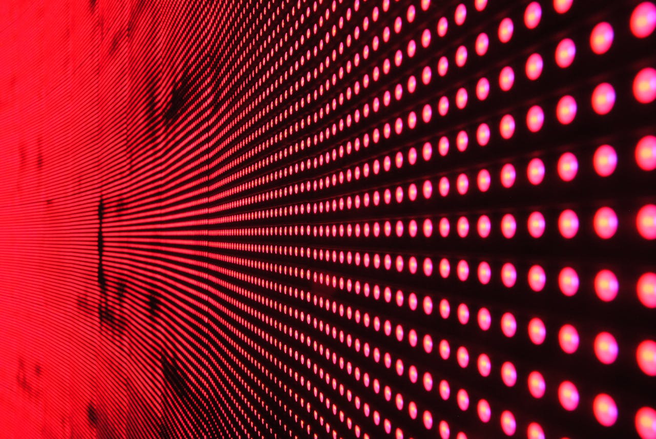 services-03 Vibrant abstract pattern of illuminated red LED lights forming a dynamic design.